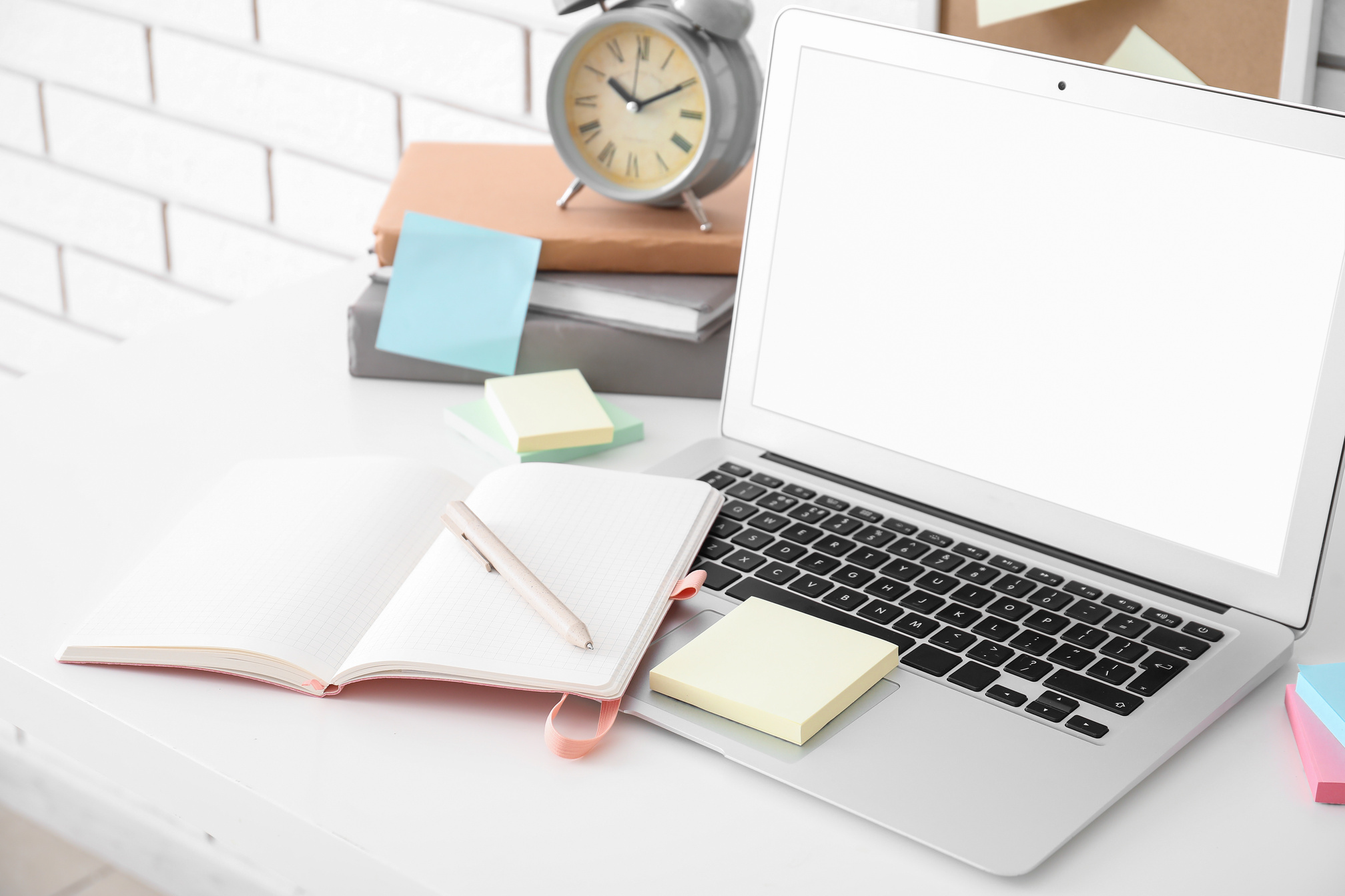 Laptop with Sticky Notes on White Table